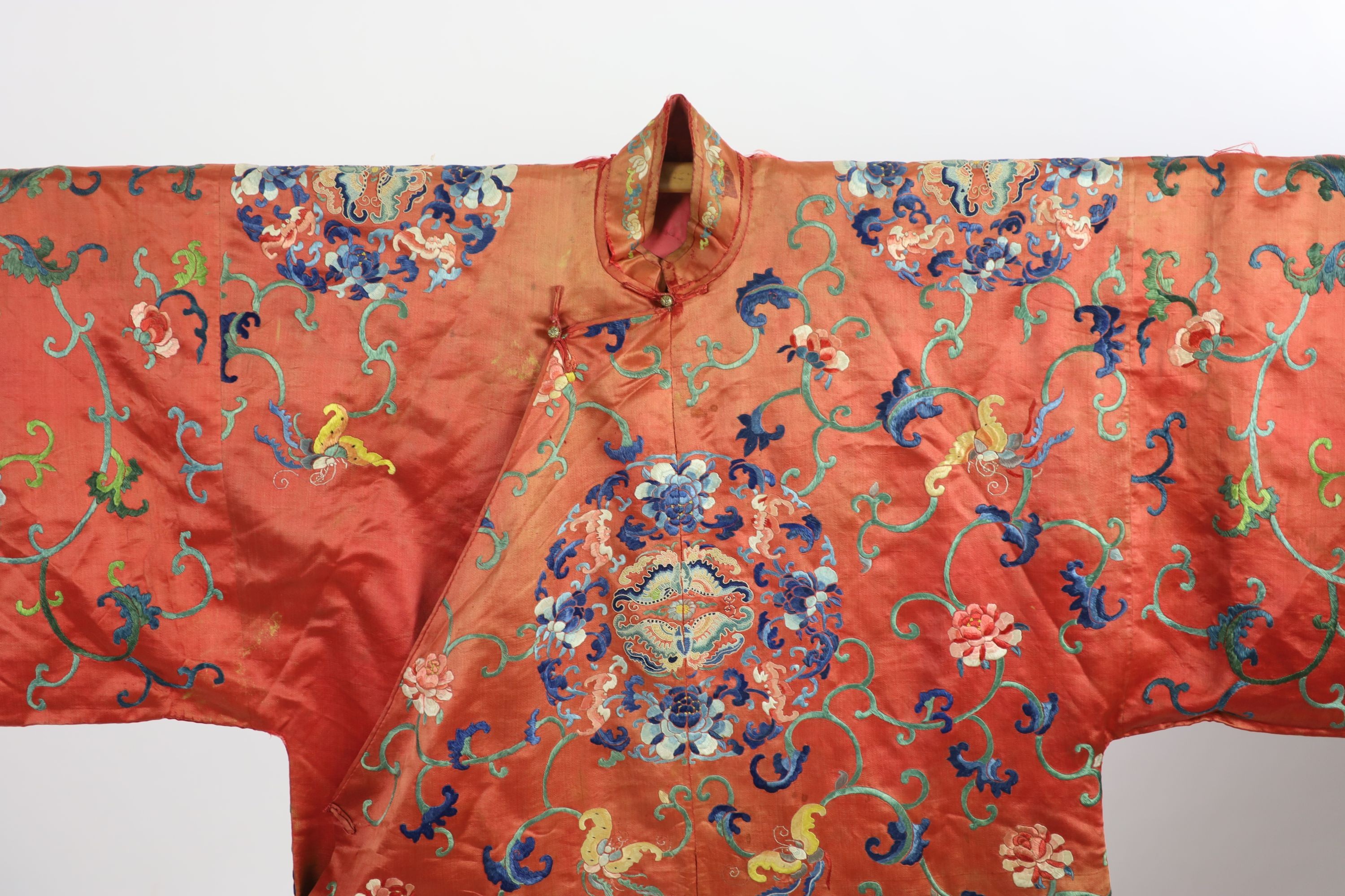 A Chinese apricot silk robe, mid 19th century, 125 cm long, wear to back of collar